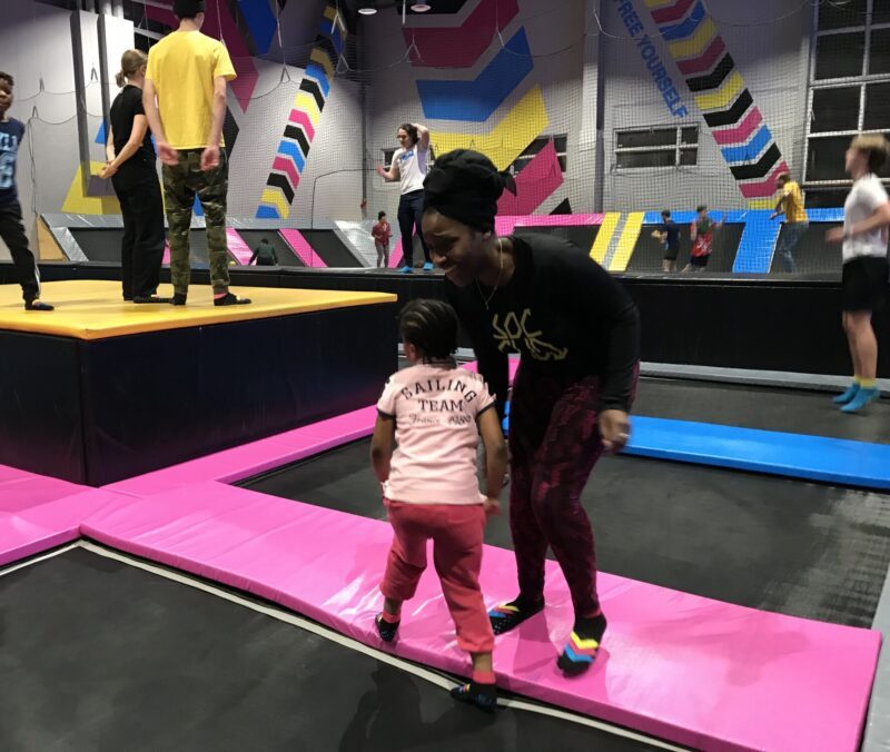 Lovette Jallow playing with Jeanine's children, providing them comfort and joy while Jeanine rests