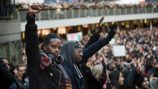 Image of crowd of people with fists in the air