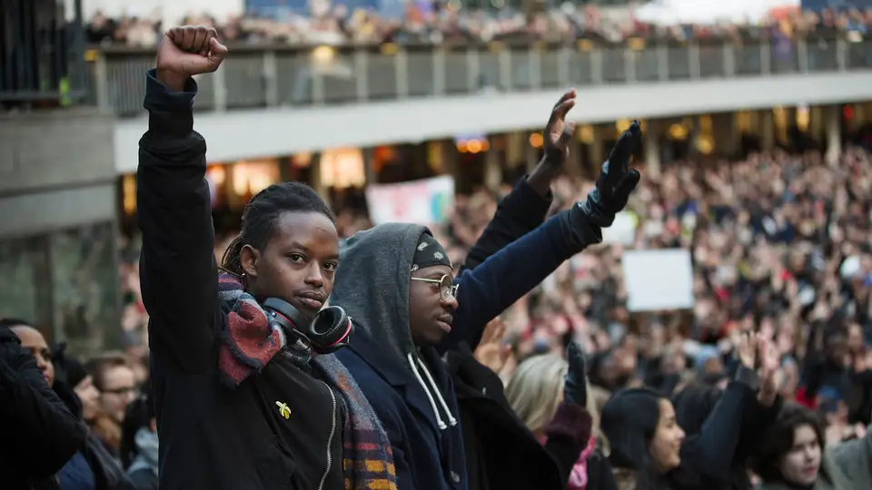 Crowd of people with fists in the air