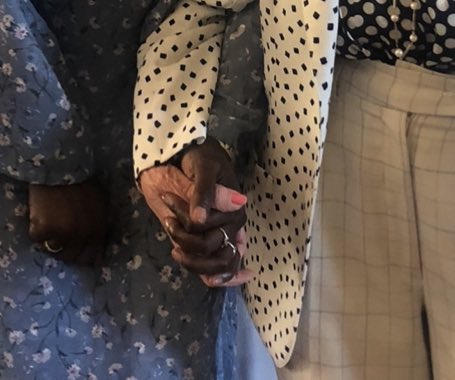 Two women holding hands